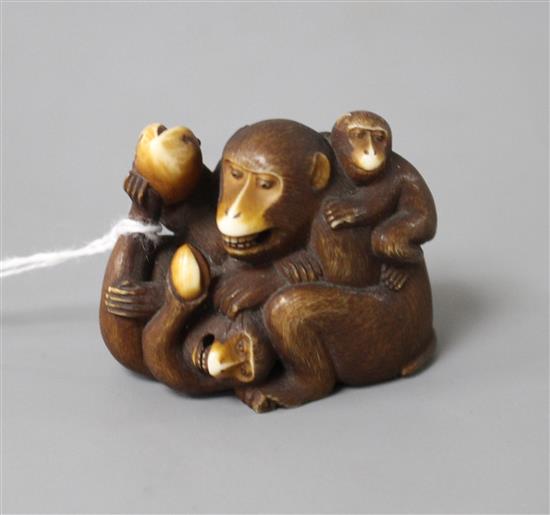 A Japanese stained ivory okimono carved as a group of apes, width 4.5cm, height 3.5cm
